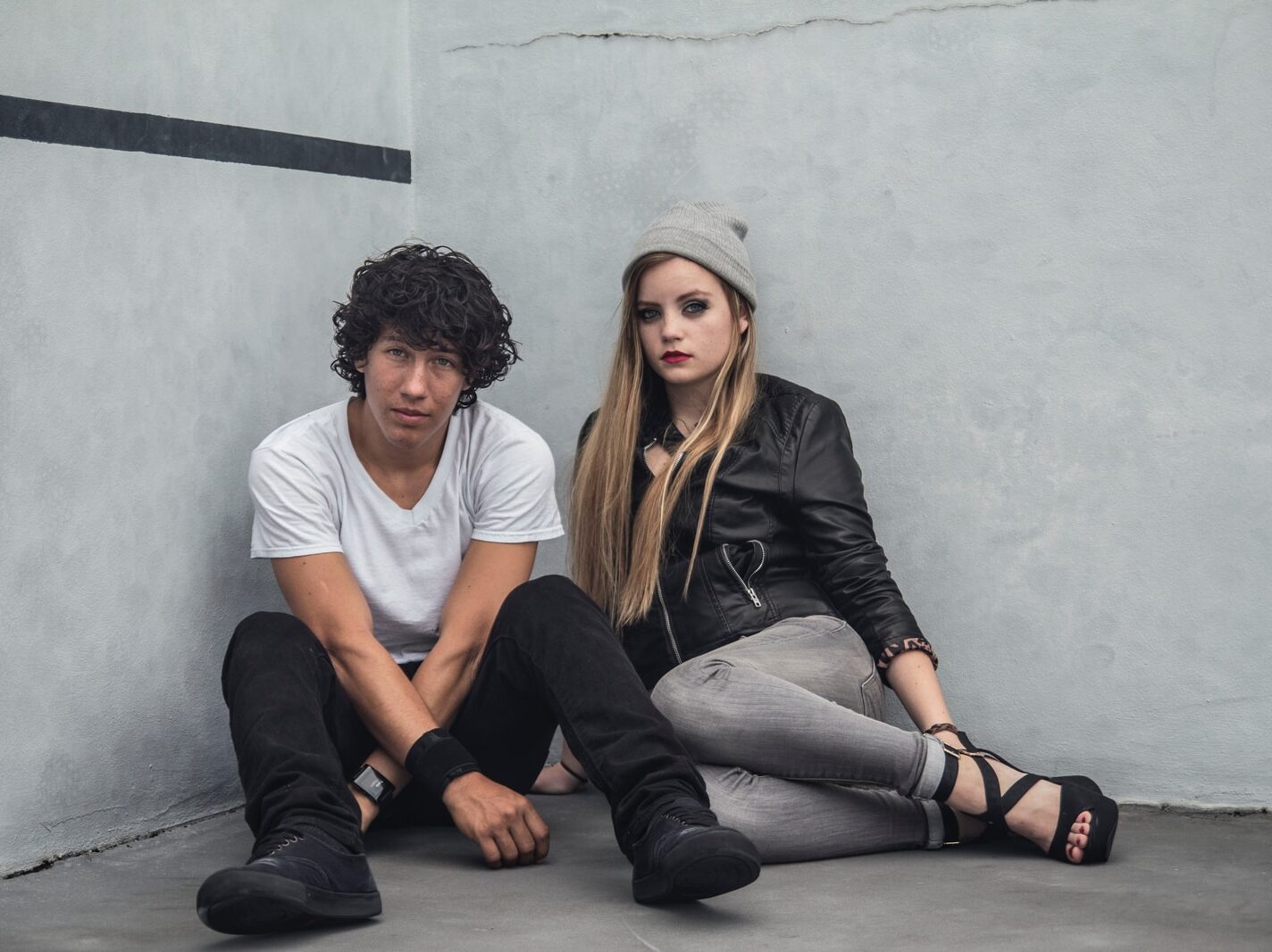 man and woman sitting on floor