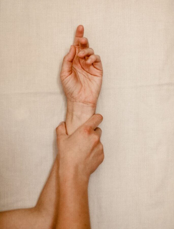 persons right foot on white textile