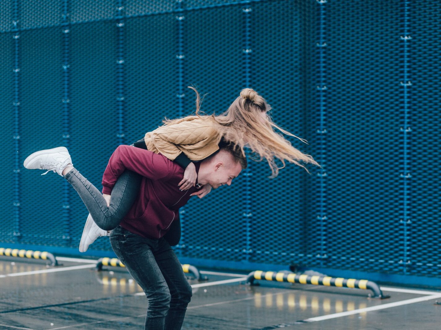man carrying woman on back