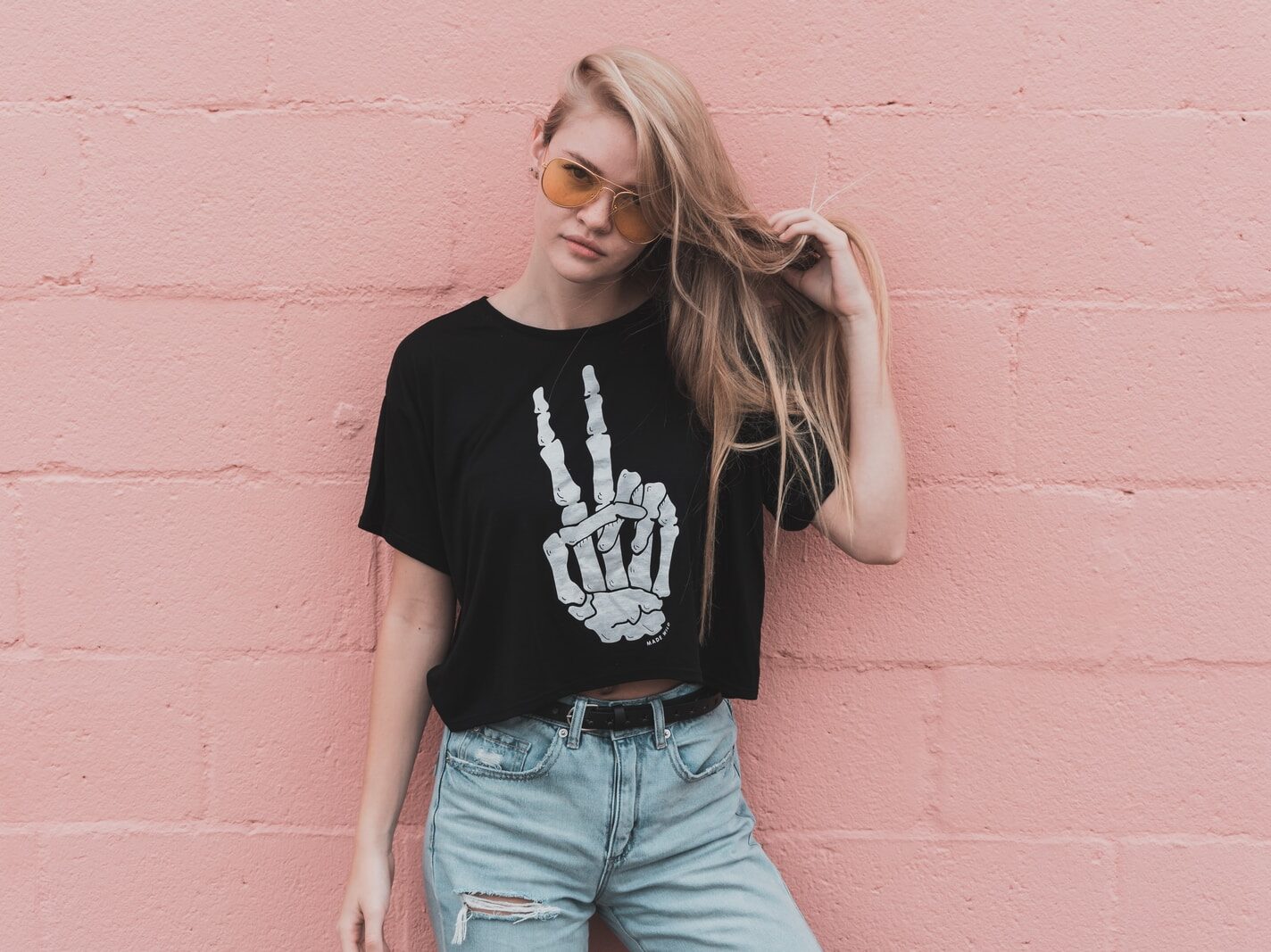 woman standing near pink concrete wall during daytime