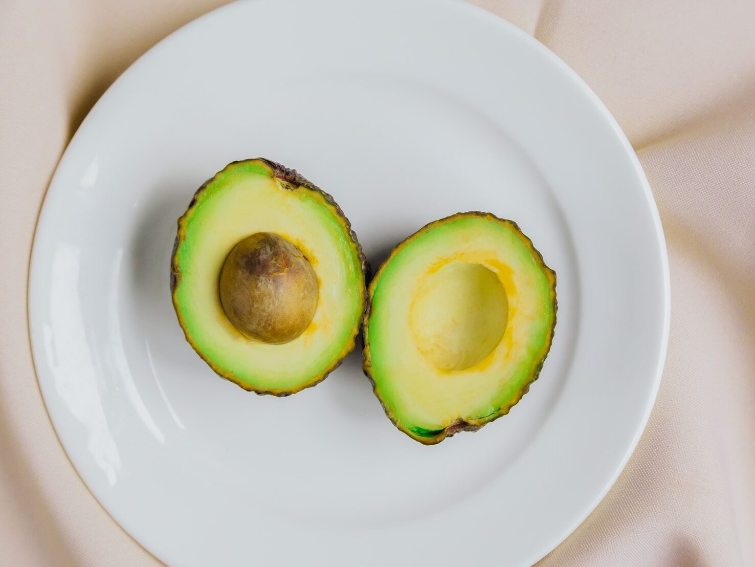 sliced avocado fruit on white ceramic plate