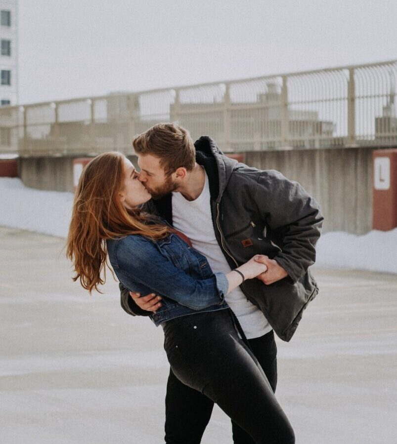 man kissing woman during daytime