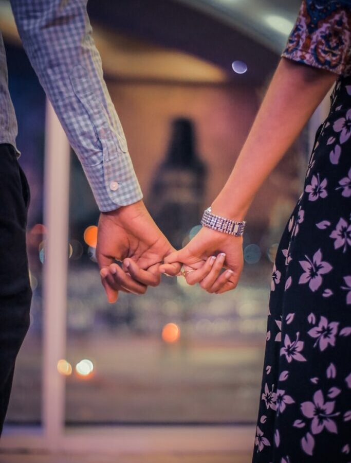 man and woman holding hands