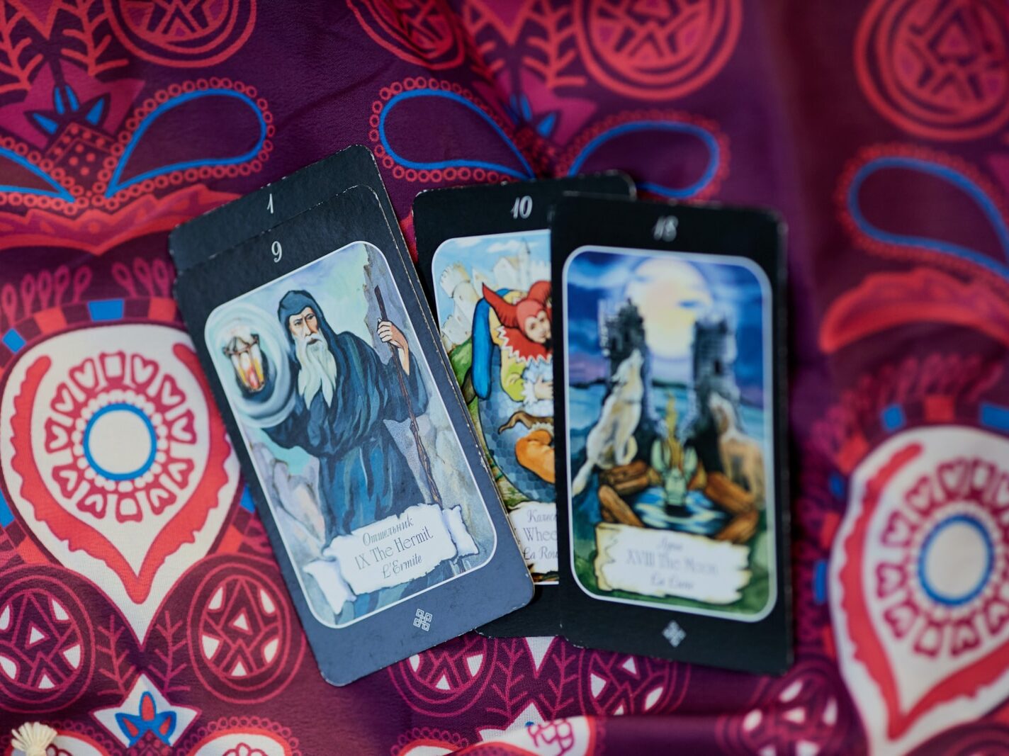 2 trading cards on red and white textile