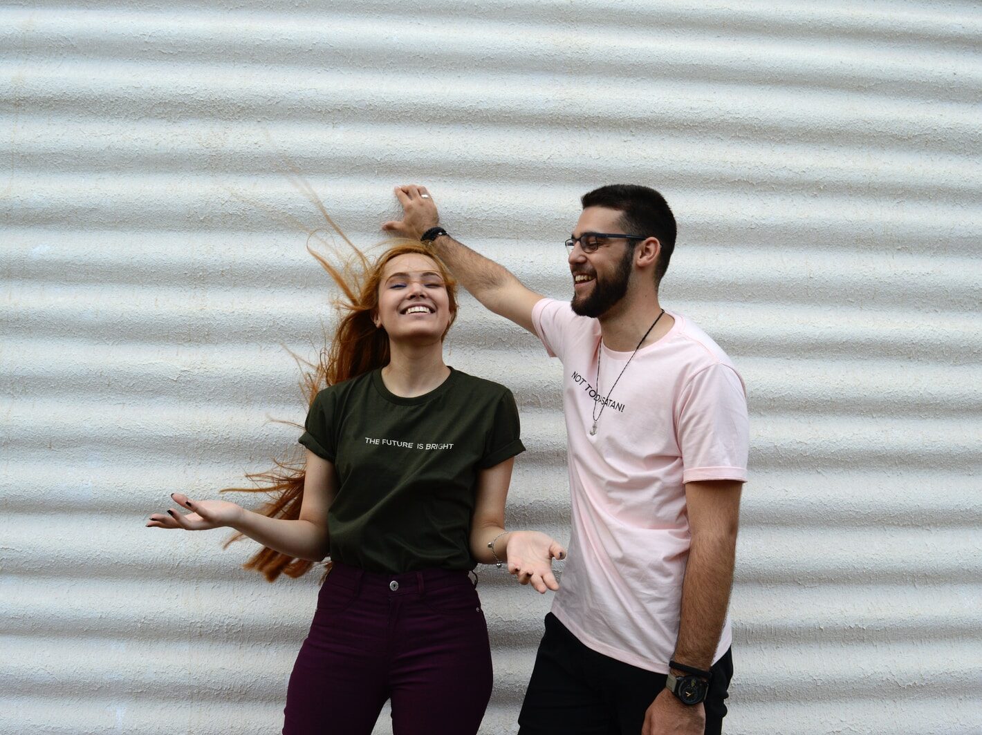 man and woman standing while chatting