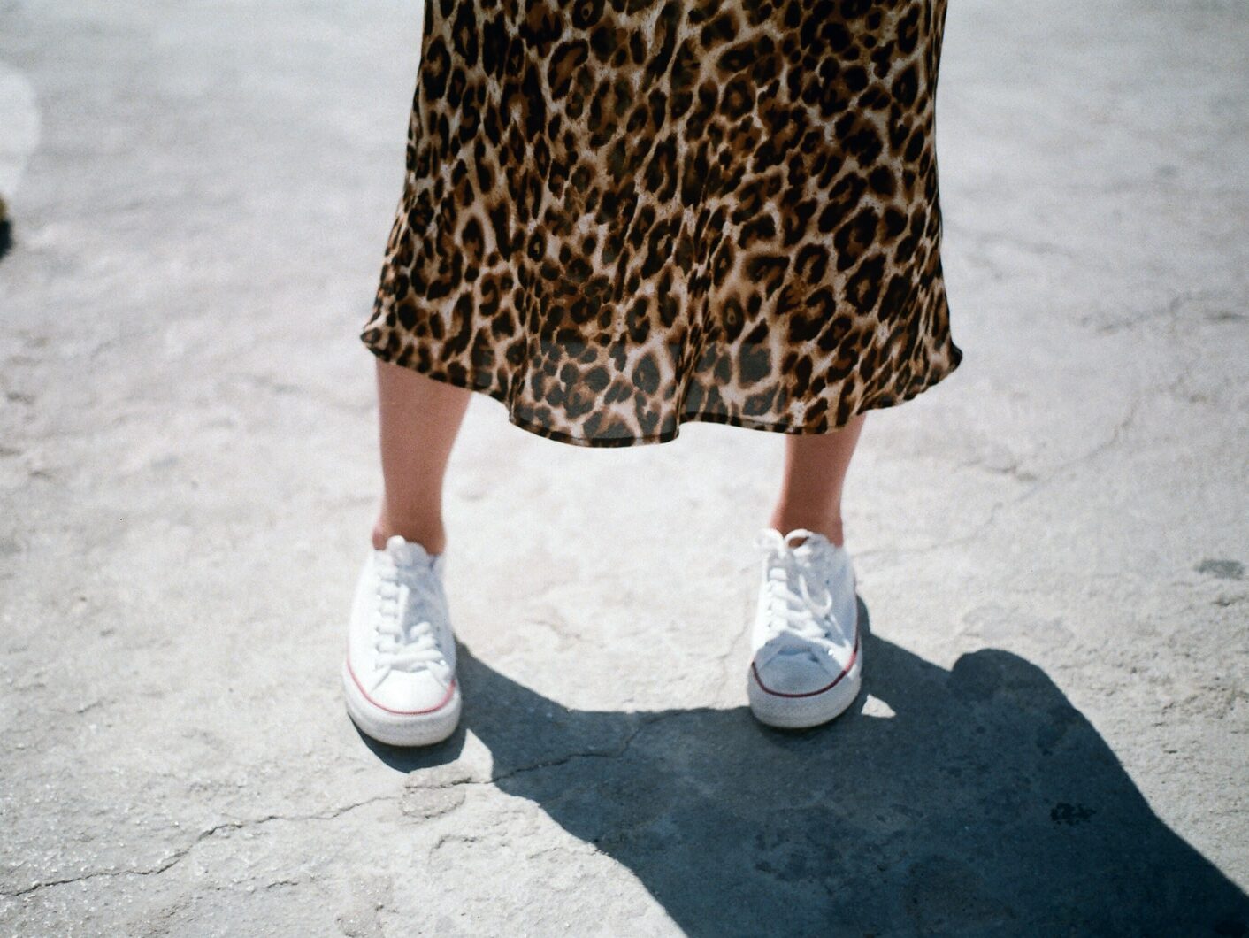 woman wearing white low-top sneakers