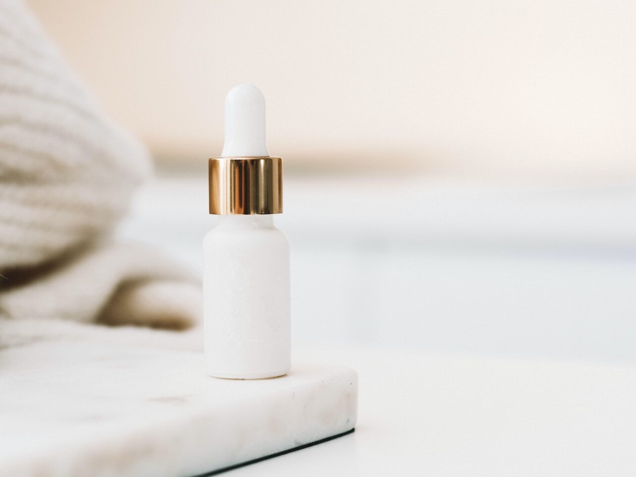 white drop bottle on white surface