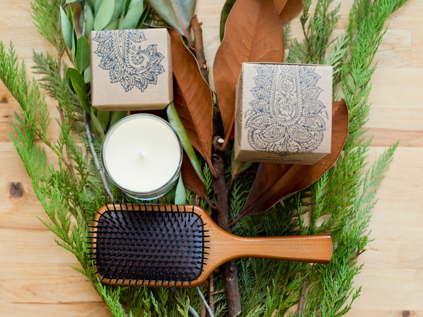brown wooden hair brush beside white round plate on brown wooden table