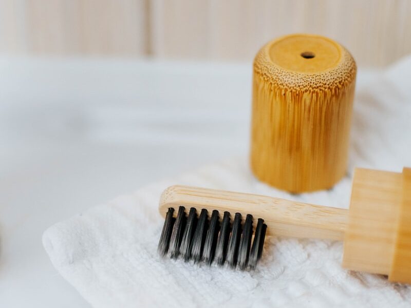 brown wooden rolling pin on white textile