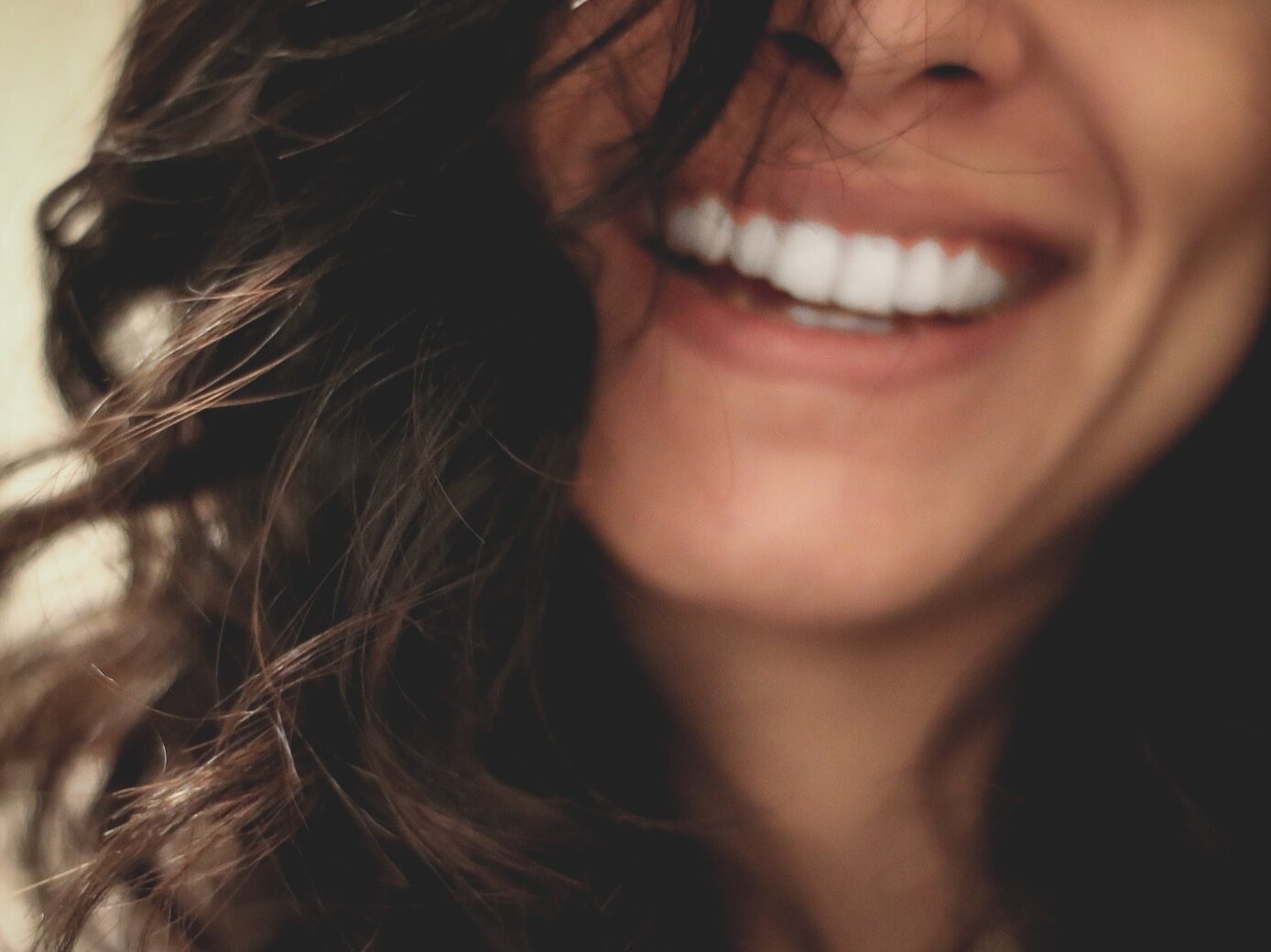 long black haired woman smiling close-up photography