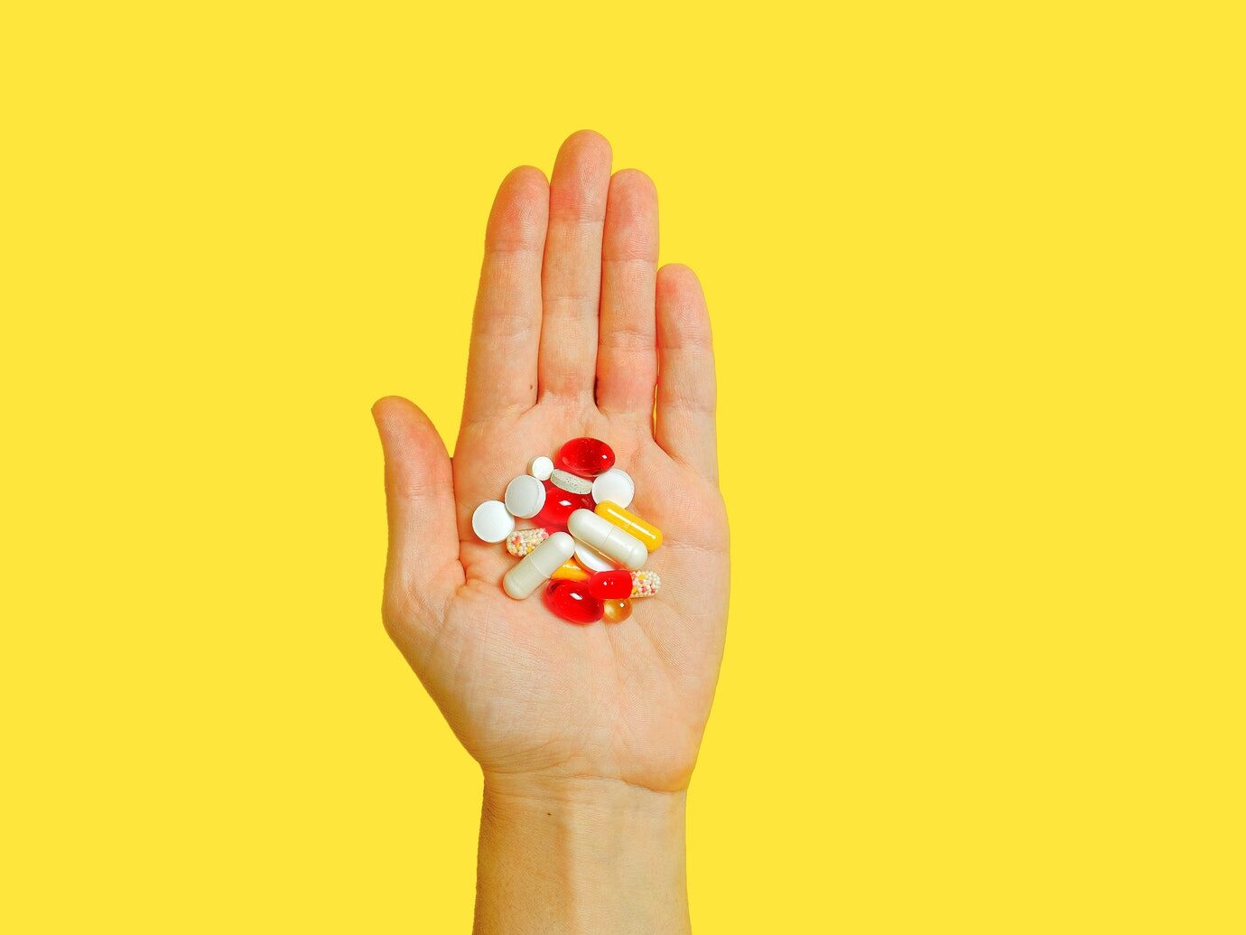 Person With Bunch Medication Pills on Hand