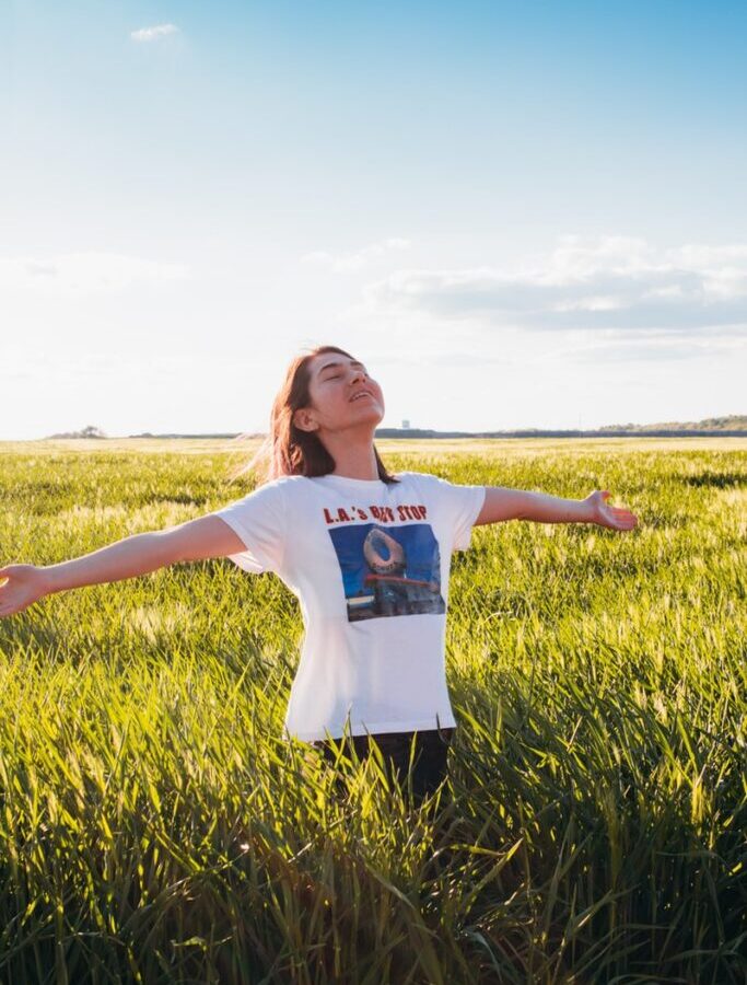 woman standing in green field