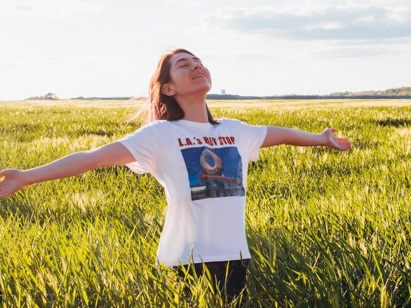 woman standing in green field
