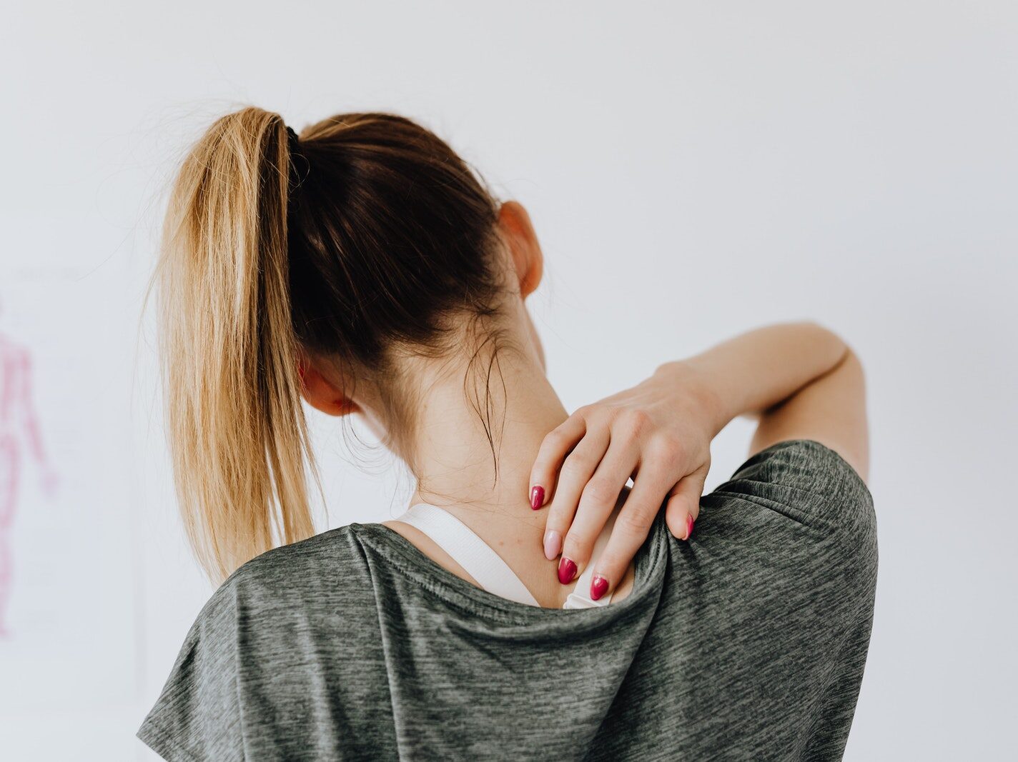 Woman Touching Her Back