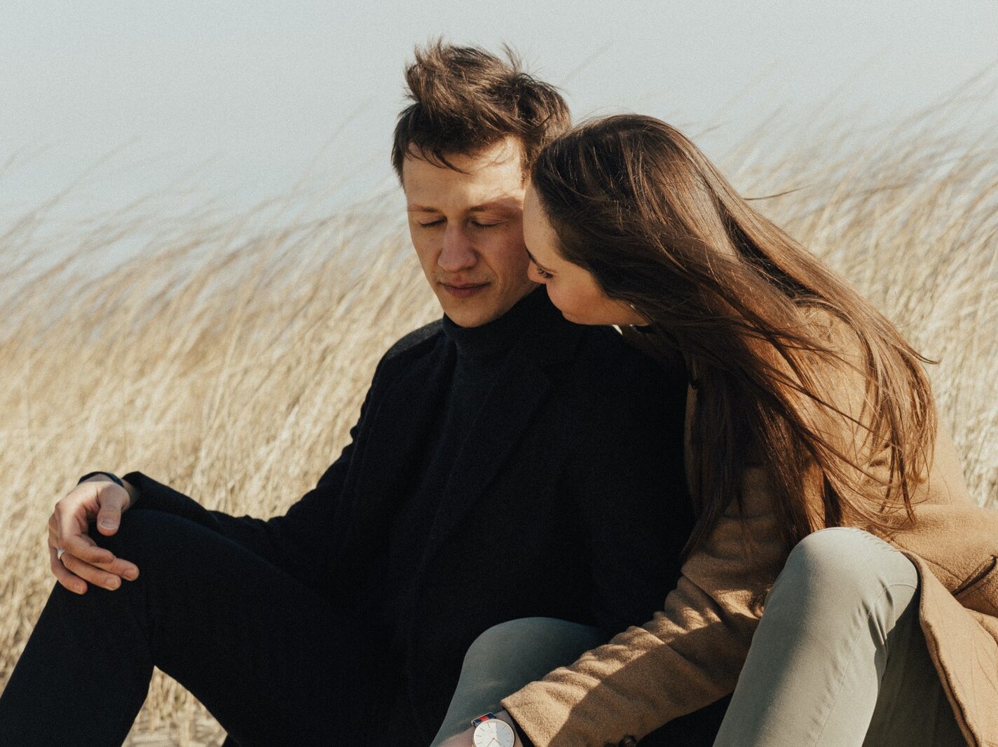 A Romantic Couple Sitting on the Sand