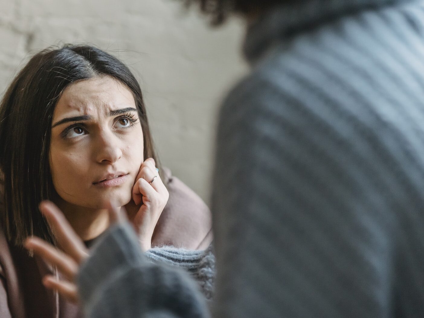 Sad woman looking at anonymous woman during conflict
