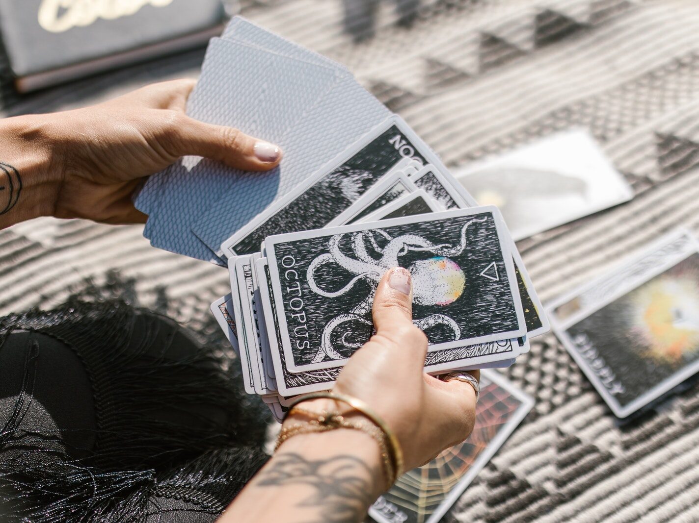 Person Holding White and Black Book
