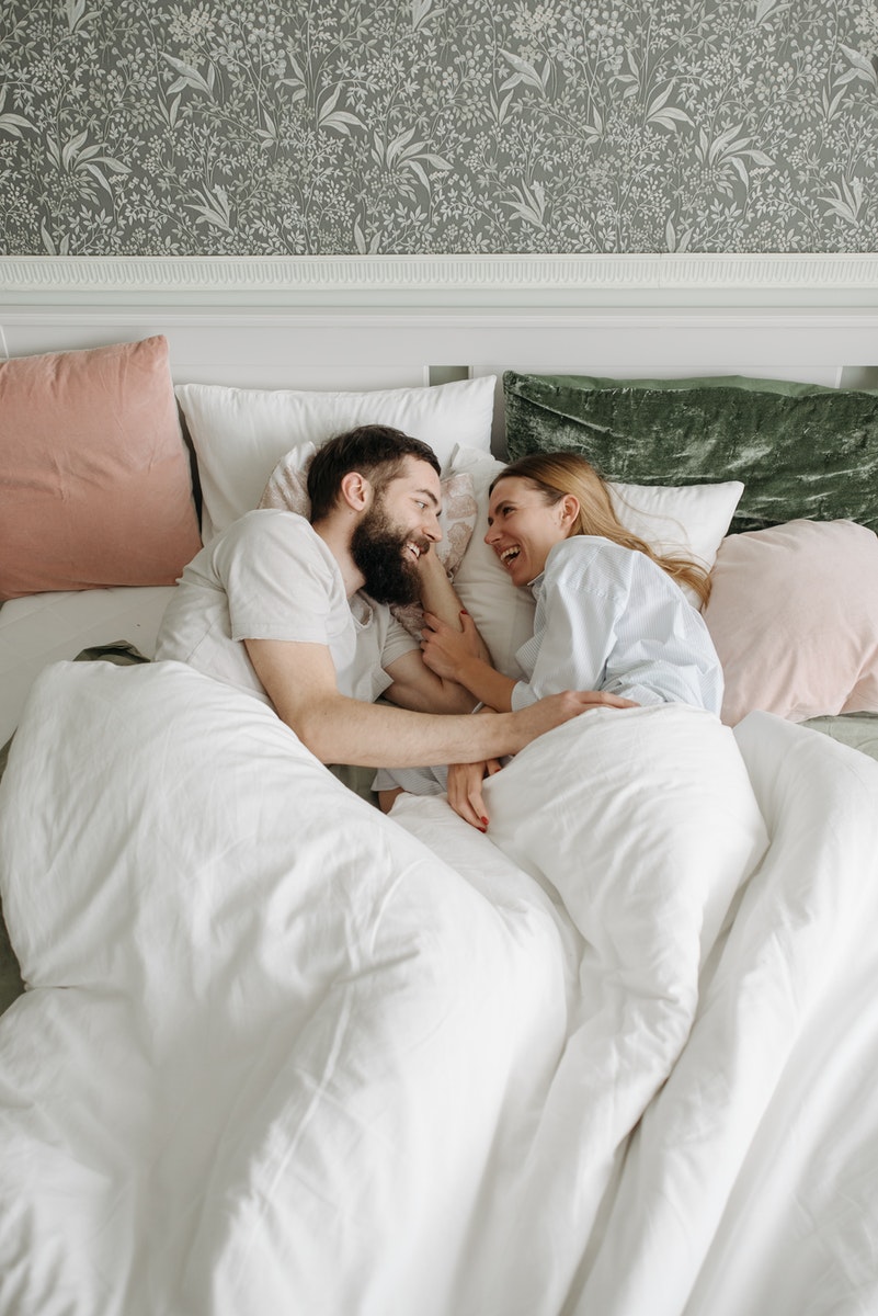 A Happy Couple Lying in Bed
