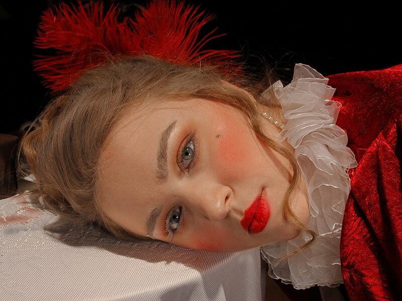 Model with red lips leaning on table