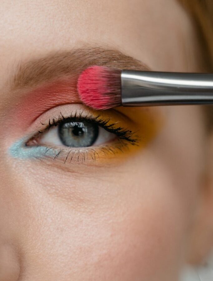 Woman Applying Pink Eyeshadow with a Brush