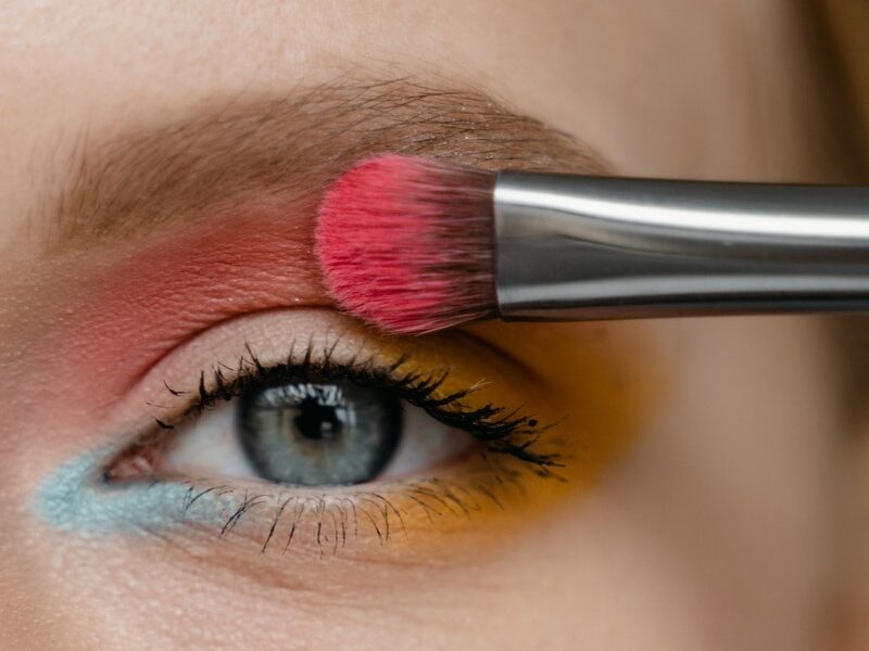 Woman Applying Pink Eyeshadow with a Brush