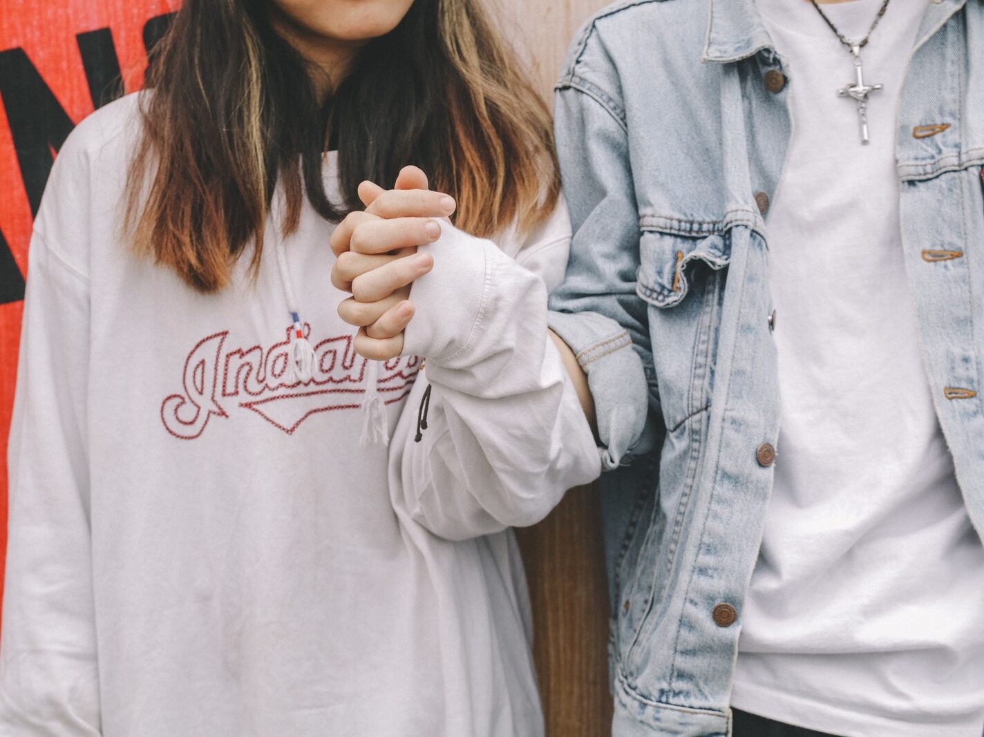 Woman Holding Man's Hand During Day