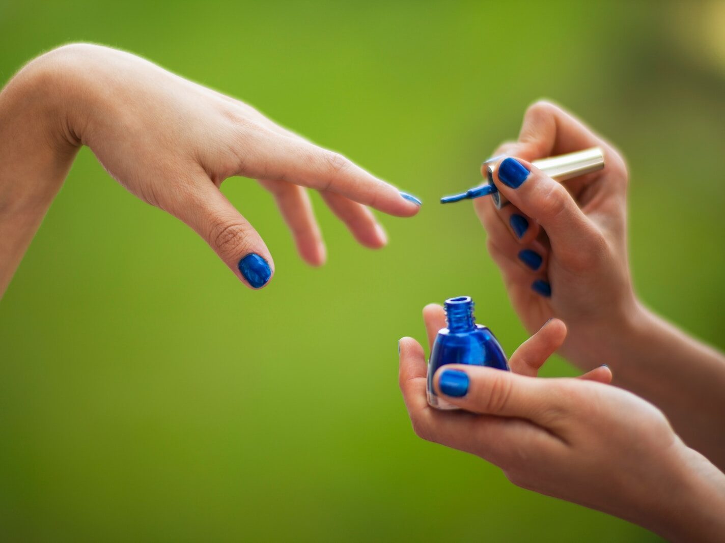 person holding blue and white plastic bottle