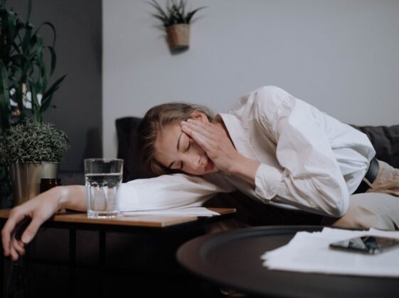 Exhausted Woman Falling Asleep On Table