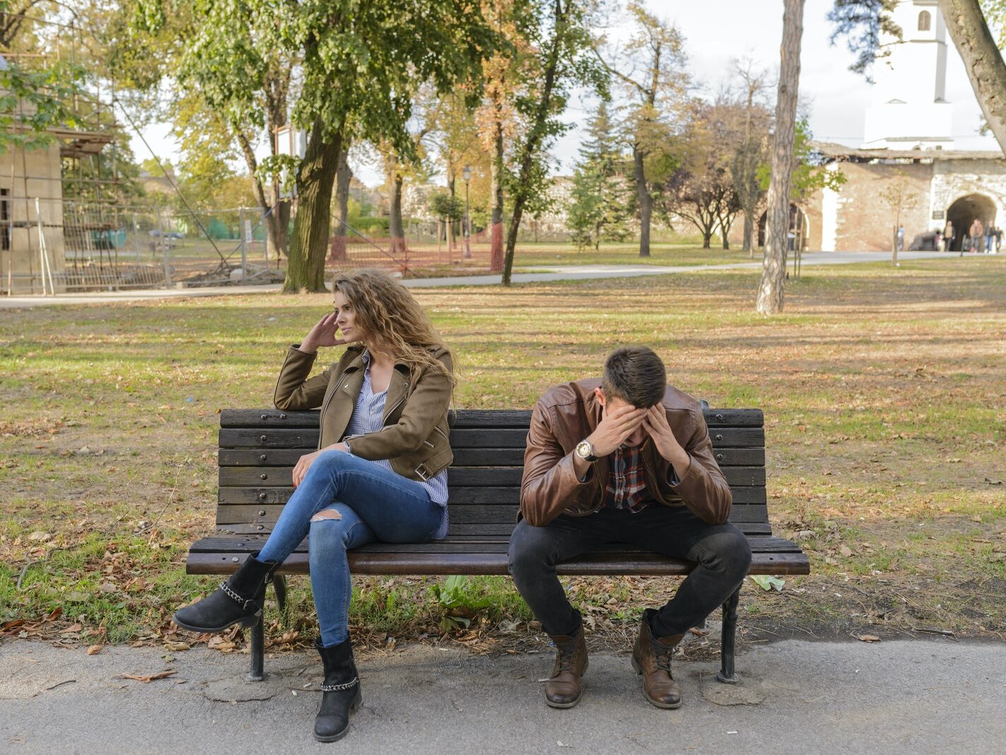 Woman And Man Sitting on Brown Wooden Bench