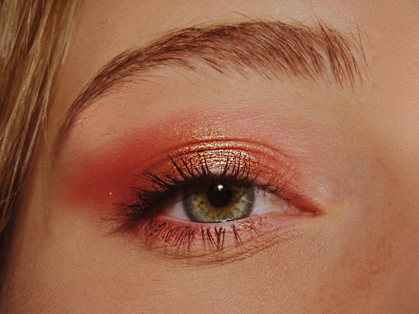 woman with pink and gold eyeshadow makeup