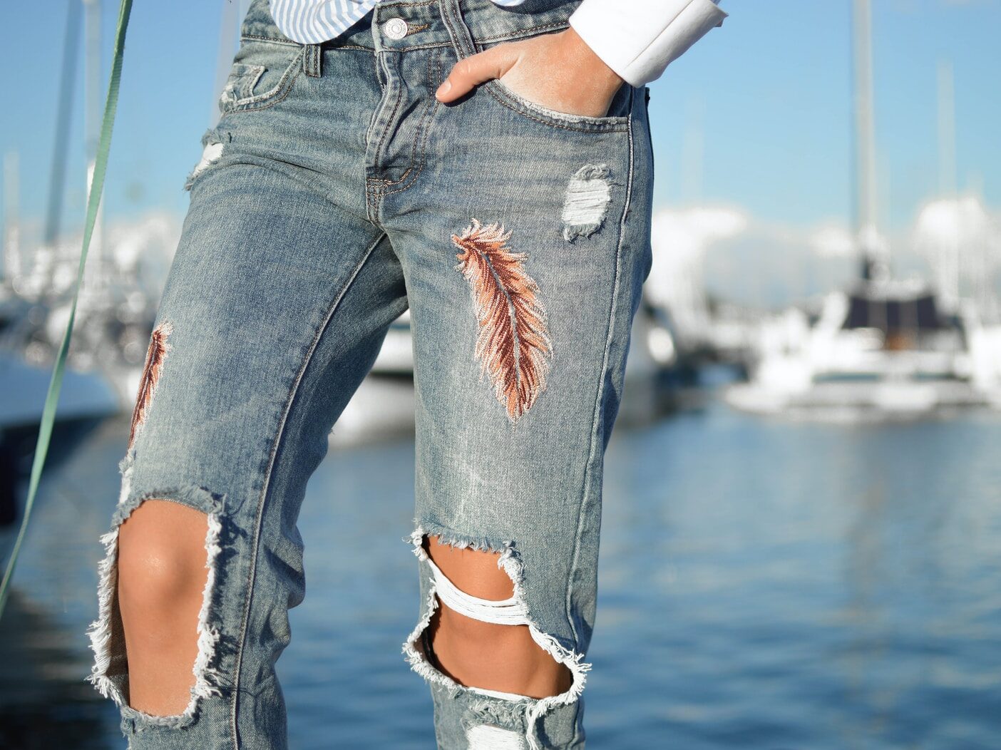 person in gray distressed pants