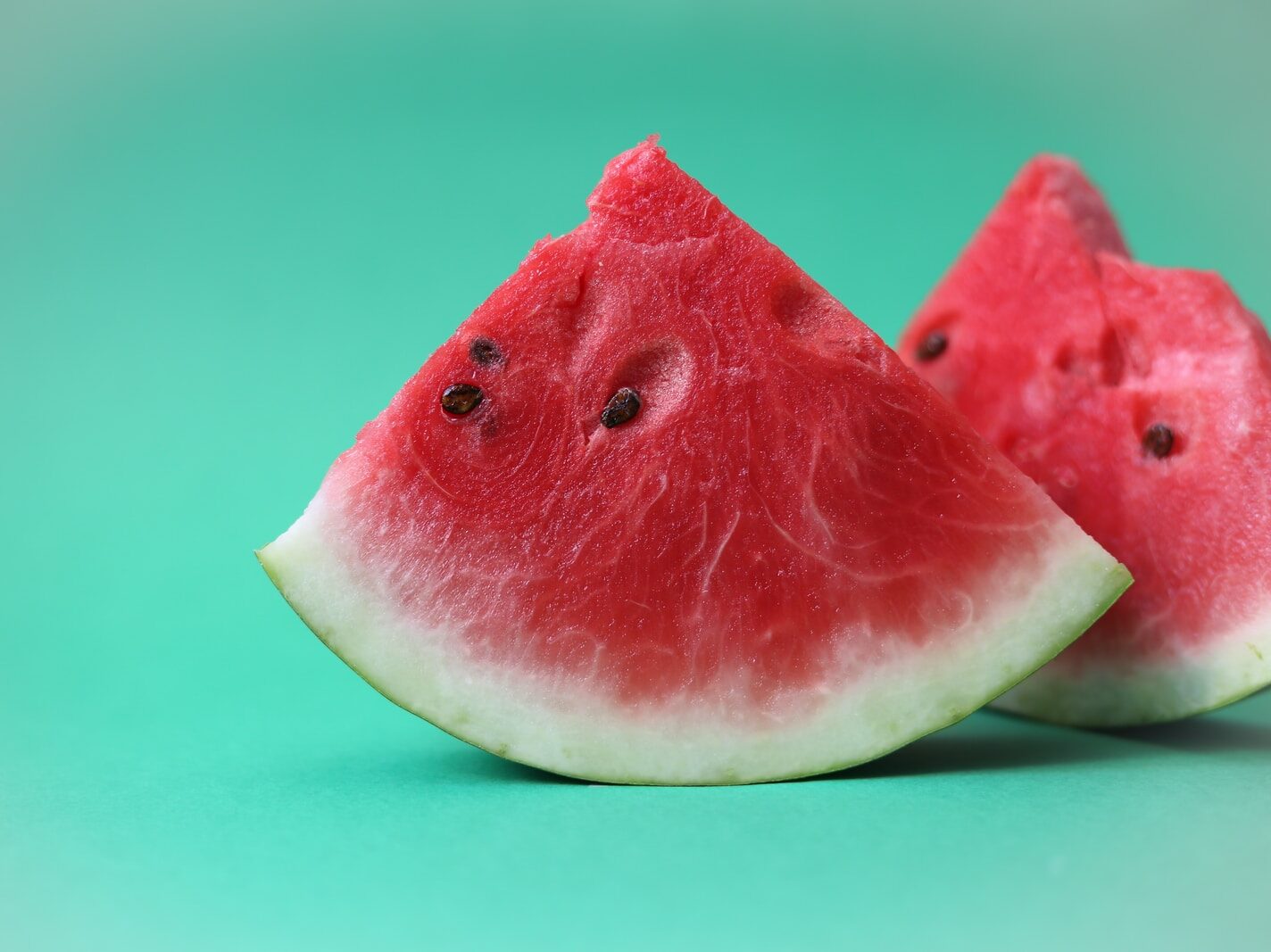 sliced watermelon on green surface