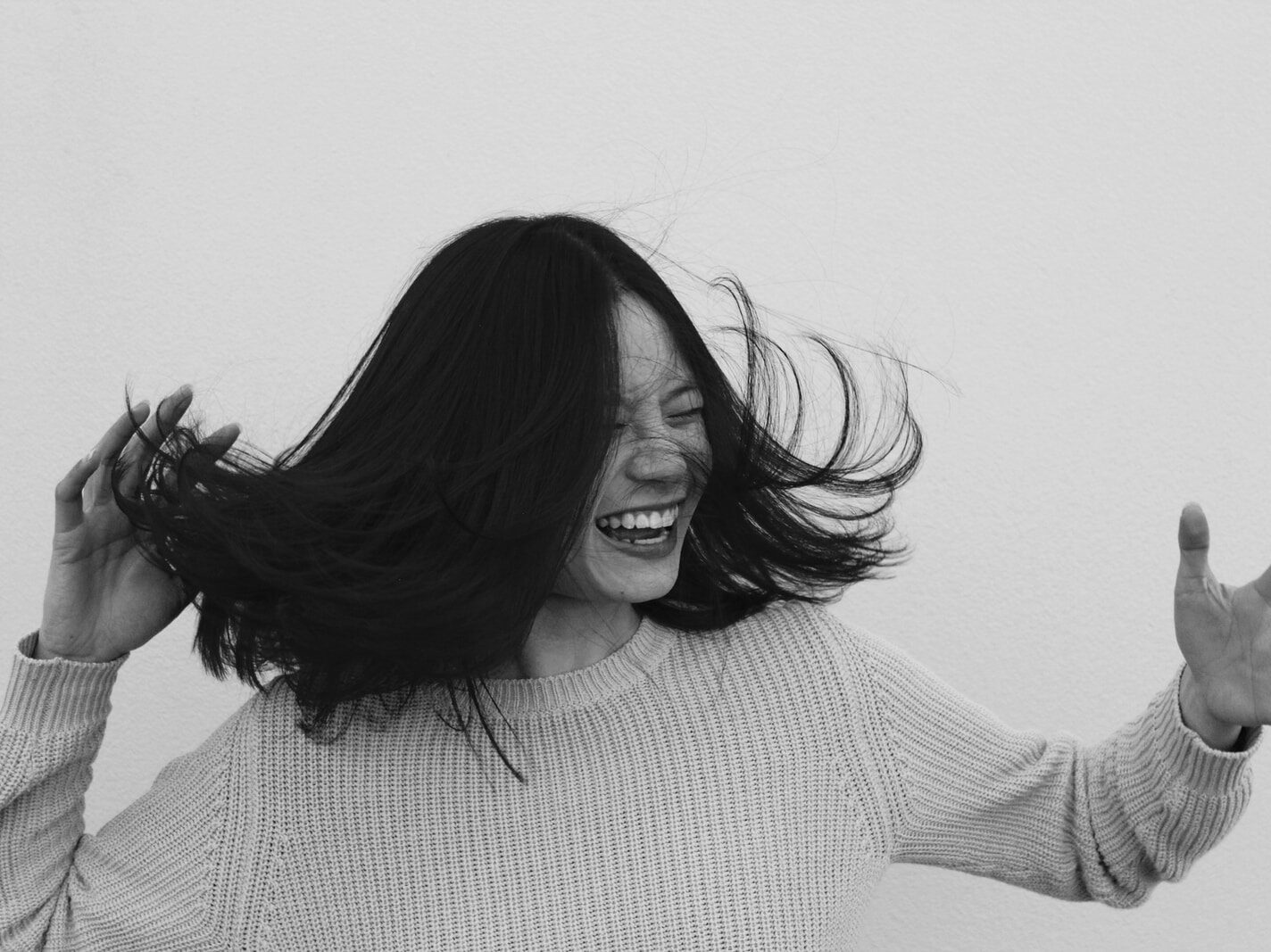 grayscale photo of woman flicking hair