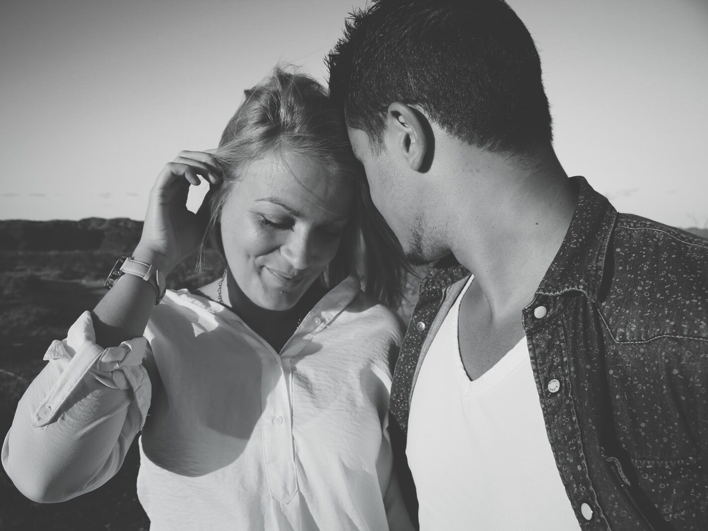 grayscale photography of man and woman