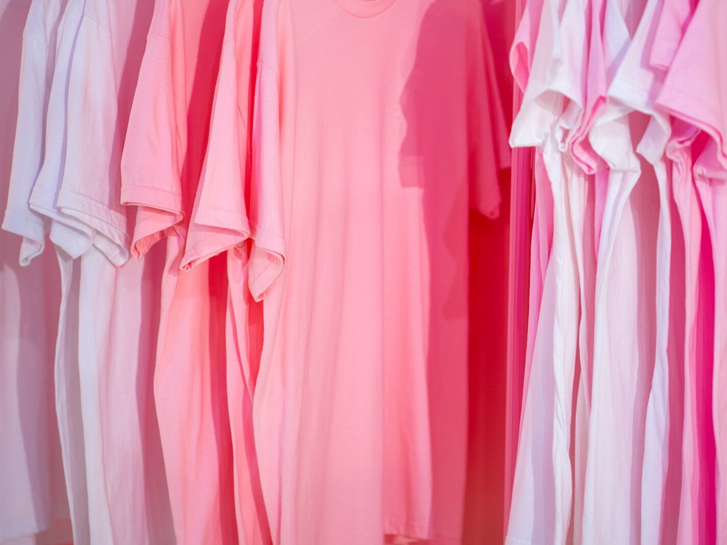photo of white and pink t-shirts