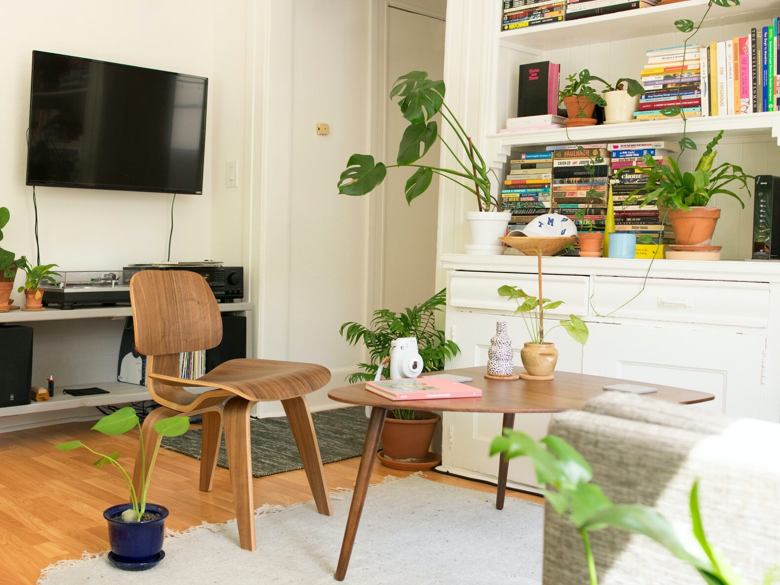 brown wooden table and chair beside bookshelf