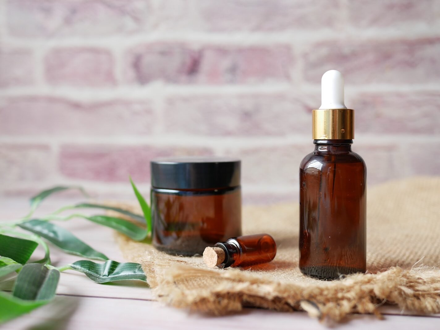 brown glass bottle on brown textile