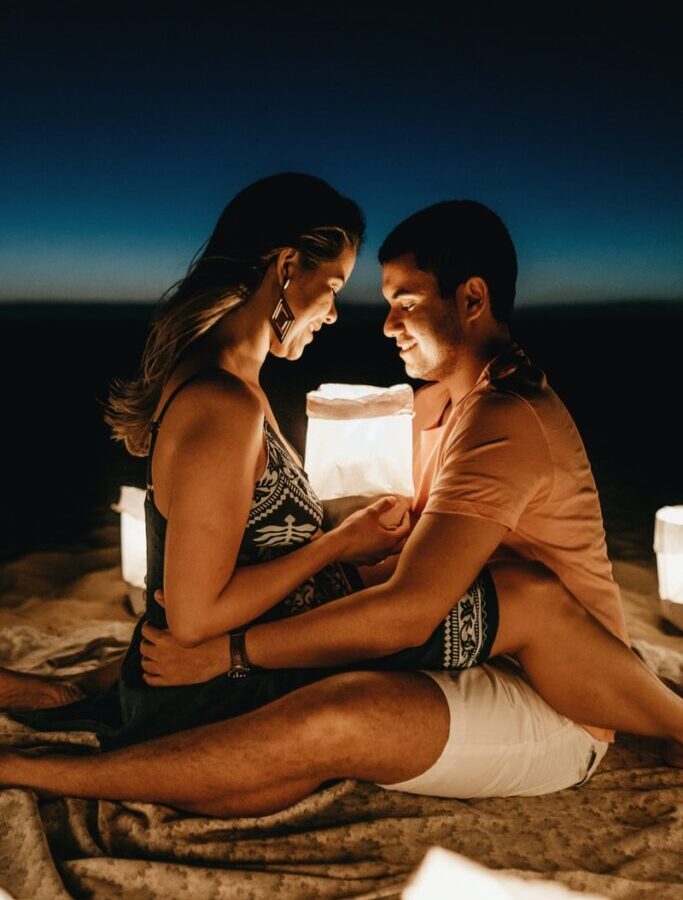 man sitting beside woman