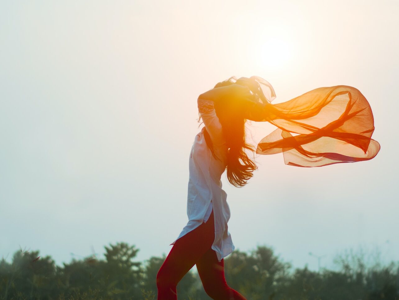 woman spreading hair at during sunset