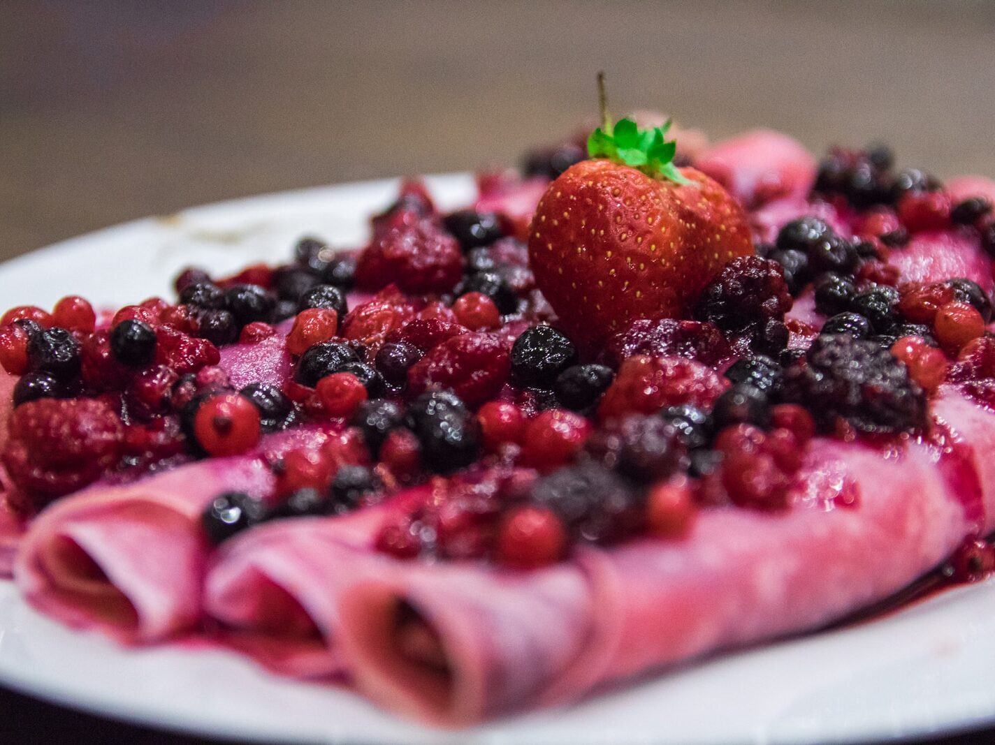 strawberry and blueberry on white ceramic plate
