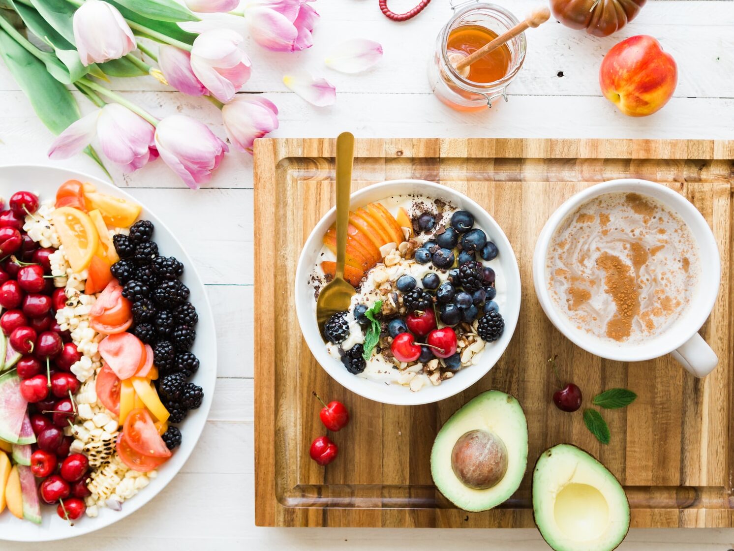 black and red cherries on white bowl