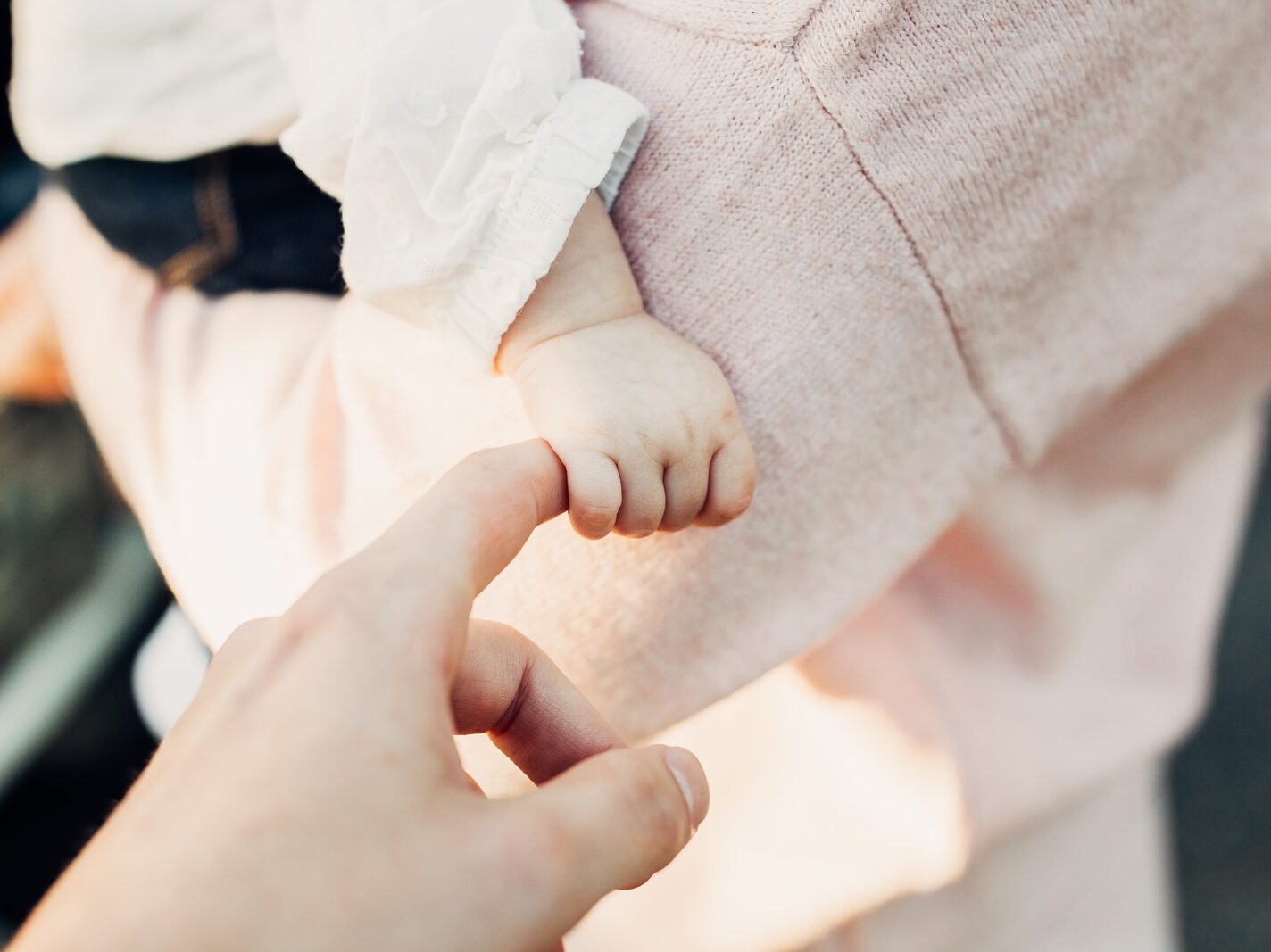 person holding baby's hand