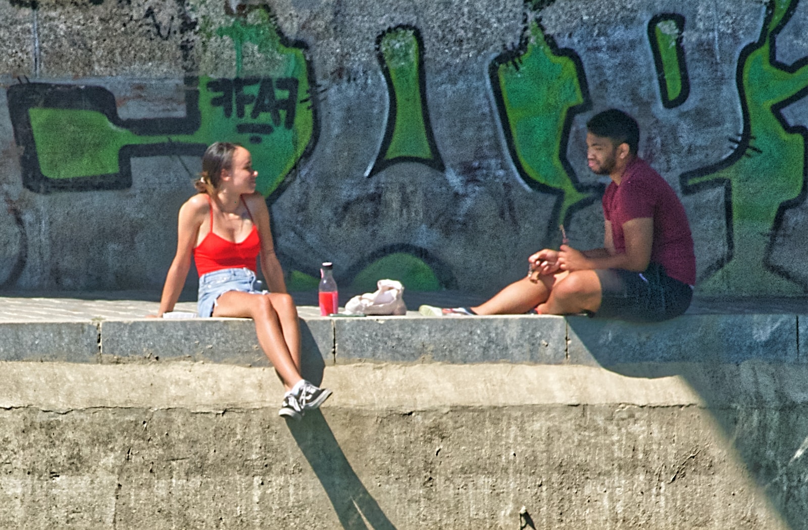 - ČasProŽeny.cz woman in red bikini sitting on concrete bench beside pool during daytime