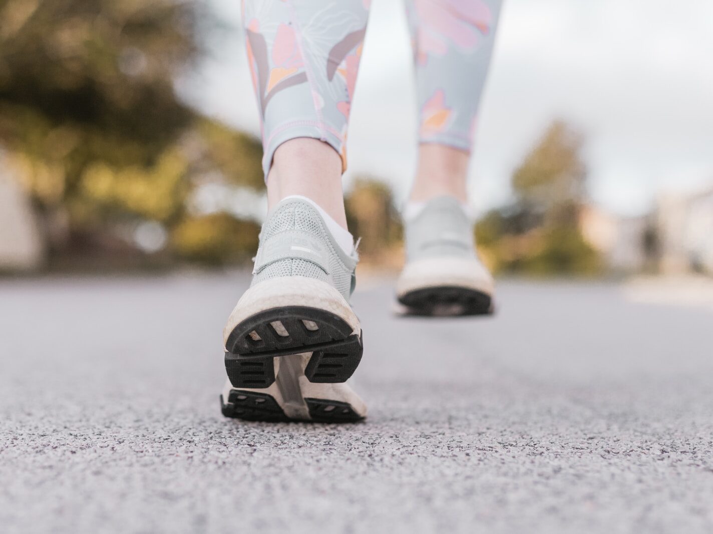 person in white and black nike shoes