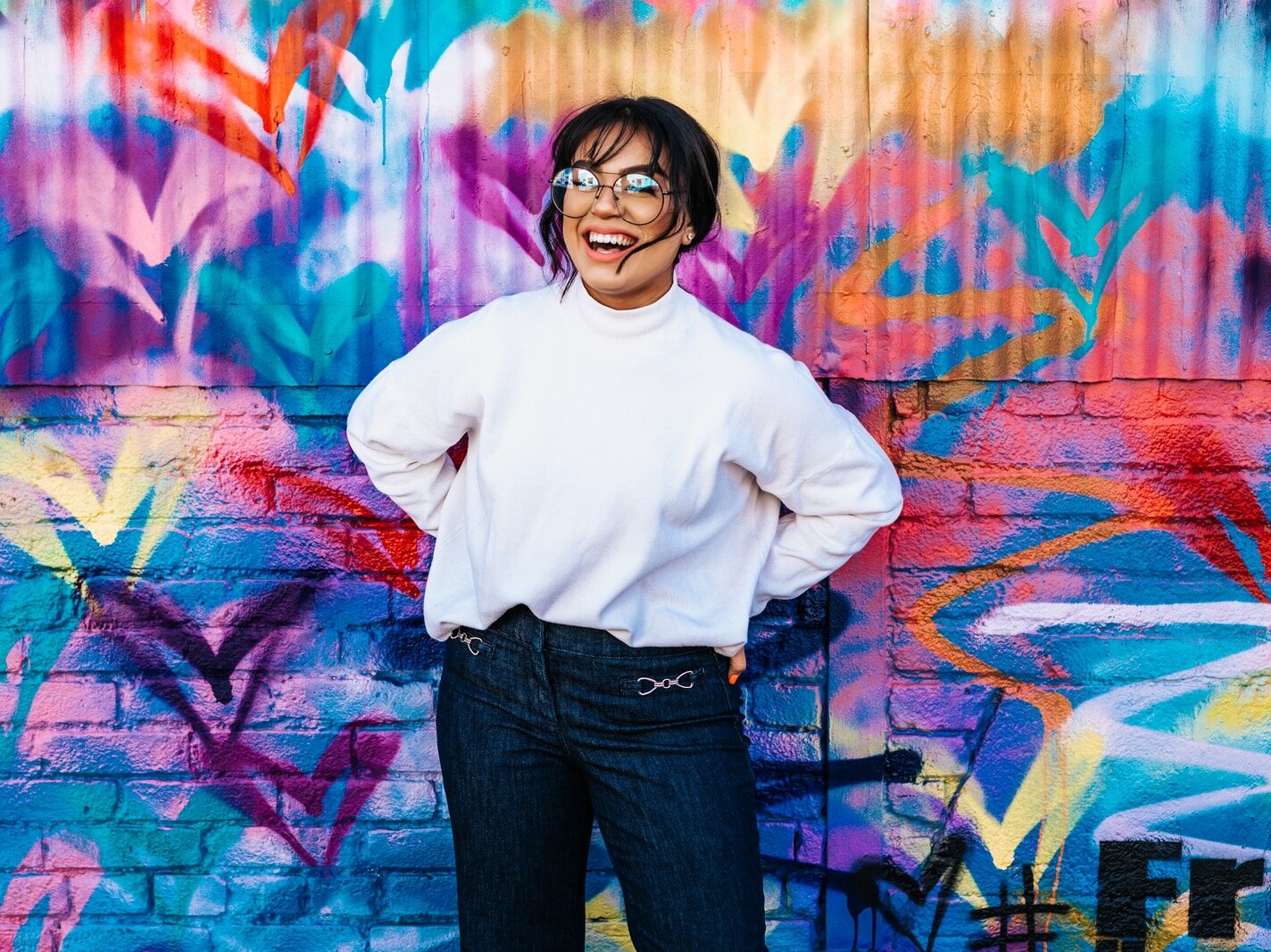 woman standing in front of multicolored wall