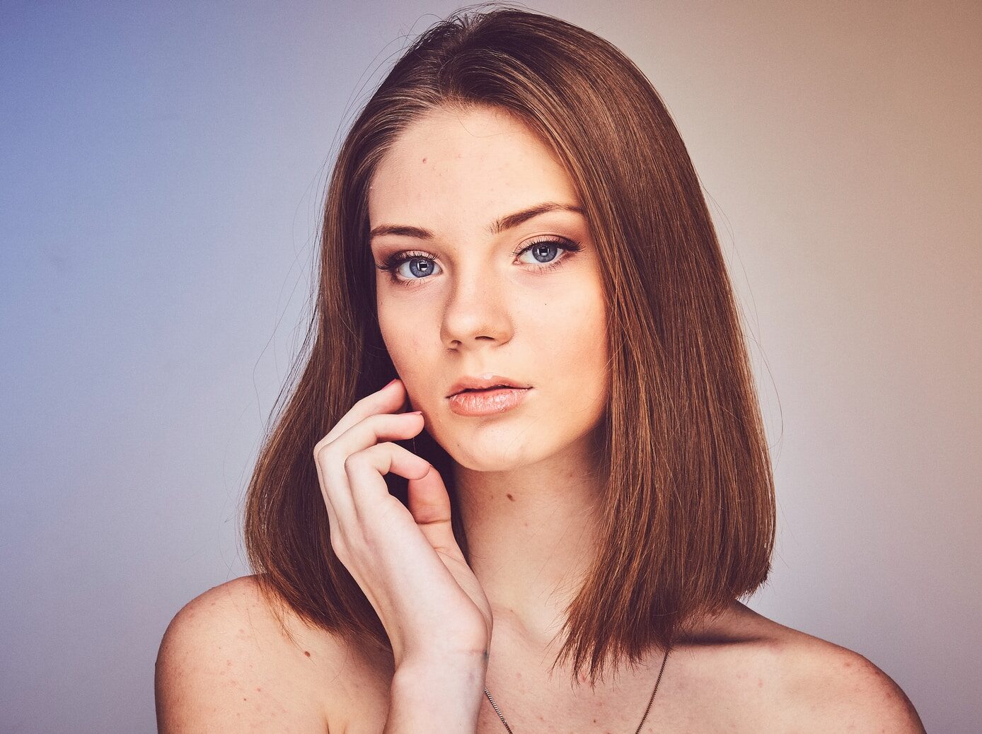 woman with her hand on cheek