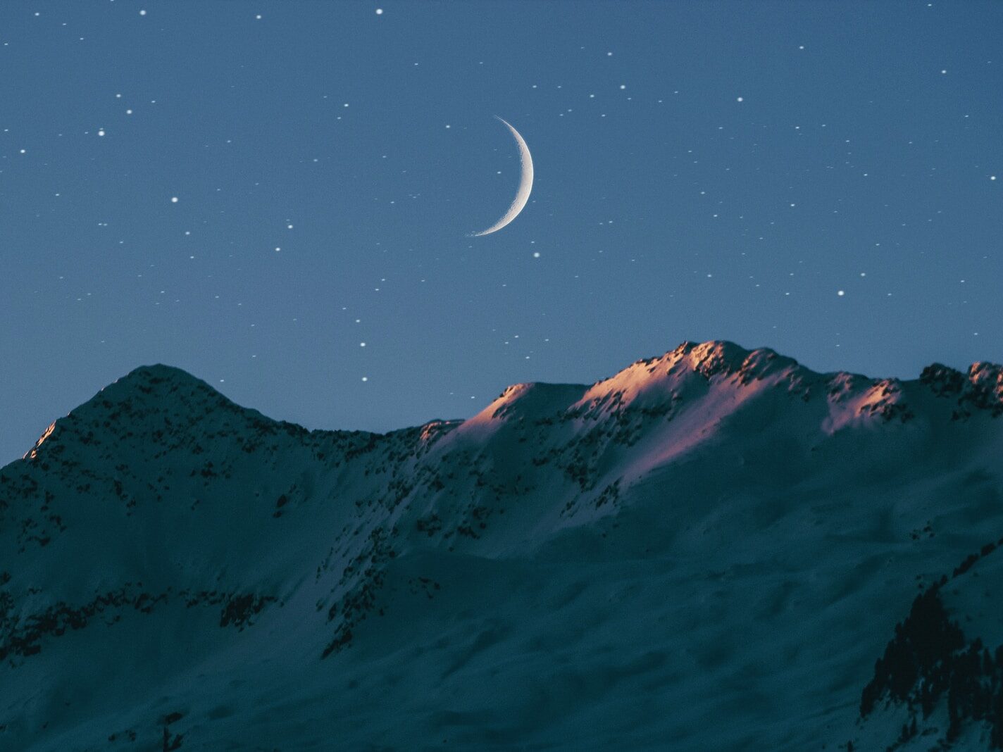 crescent moon above mountain