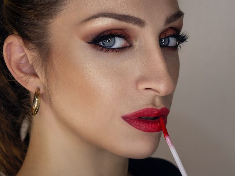 woman with red lipstick and black mascara