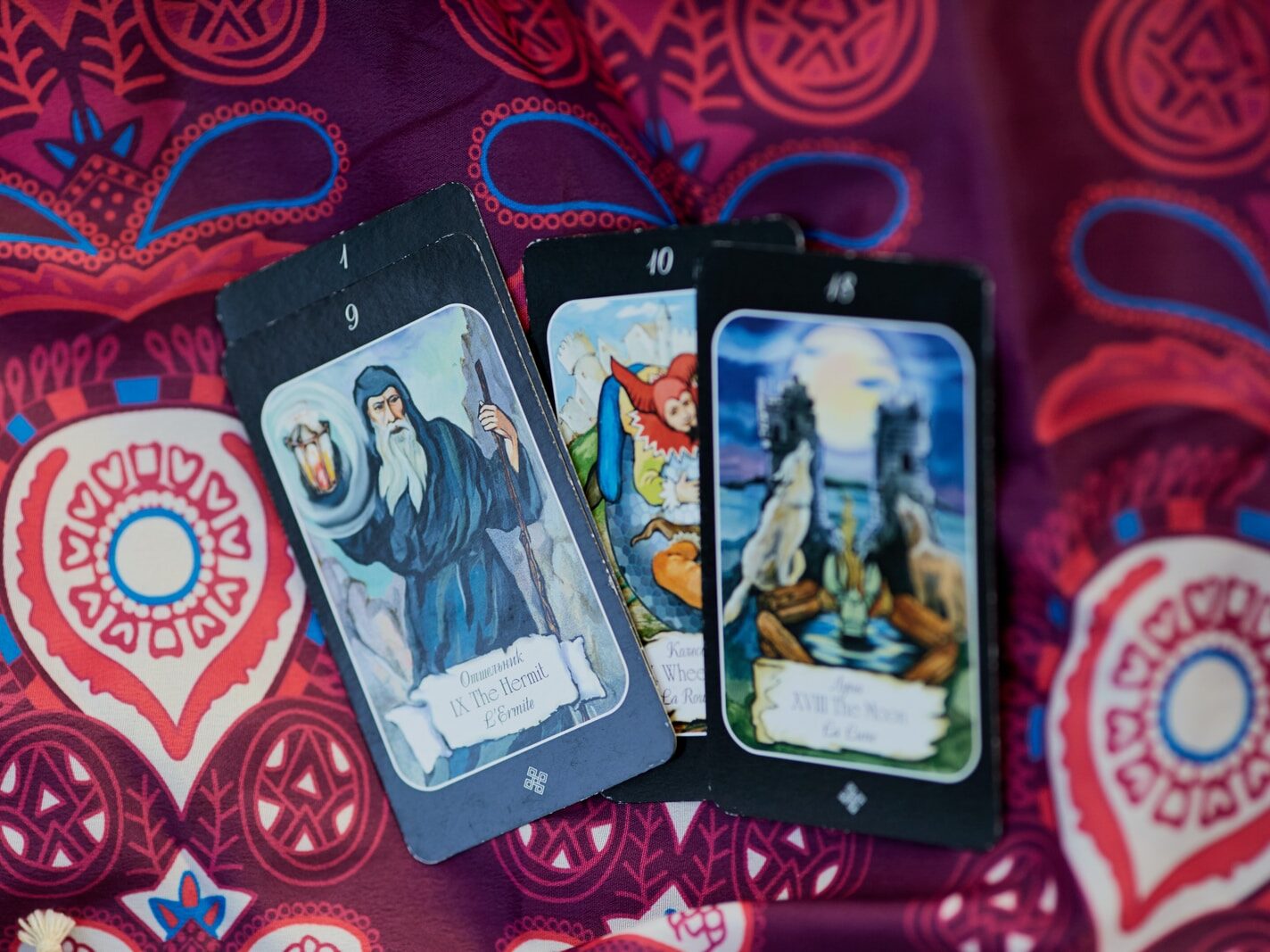 2 trading cards on red and white textile