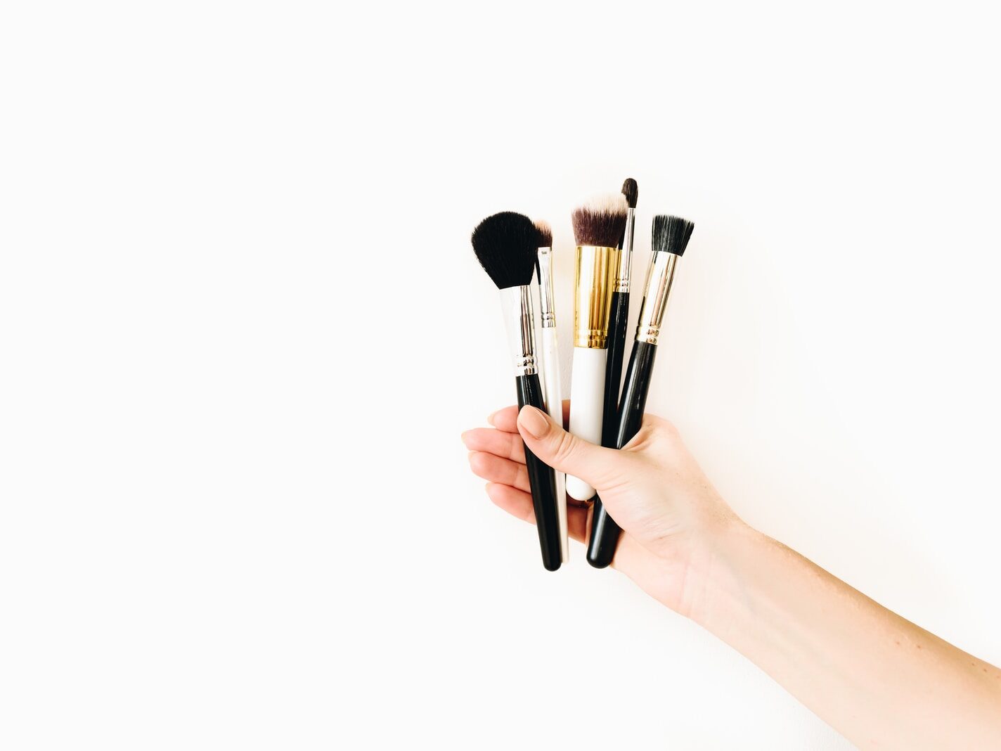 person holding black makeup brush